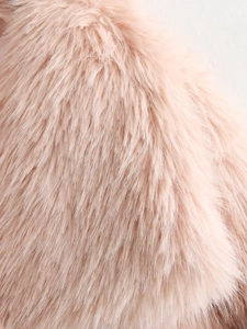 Detailed macro view of soft pink faux fur material with fluffy texture and glossy finish