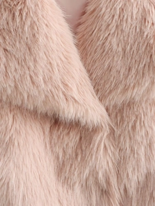 Close-up of soft pink faux fur material showing the dense long-pile texture of the coat