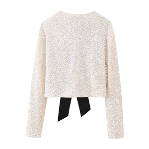 Slim fit Y2K silver sequin long sleeve top featuring a large black bow tie on the back