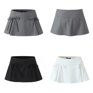Detail view of bow tie and pleated hem on grey, black, and white mini skirts