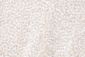 Macro view of white sequins and delicate embroidery on Y2K slim-fit shirt fabric