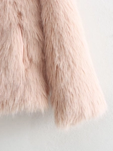 Close-up of soft pink faux fur texture on a thick Y2K style winter coat for women