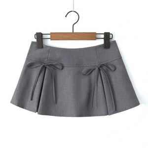 Detail view of a grey A-line mini skirt featuring decorative bows and pleated texture