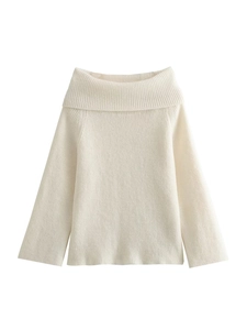 Close-up of cream knit sweater showing vertical ribbed texture and off-shoulder neckline