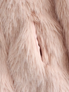 Detail view of pink faux fur coat showing soft plush texture and high-quality inner lining