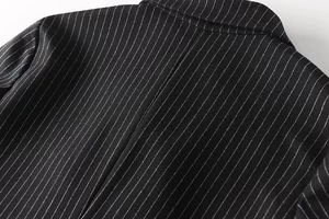 Detailed close-up of the black pinstripe blazer collar with high-quality stitching