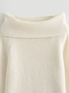 Detail of beige ribbed knit sweater collar and soft texture on clean background