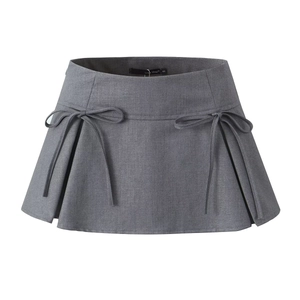 Close-up of a grey A-line mini skirt featuring decorative bows and pleated schoolgirl details