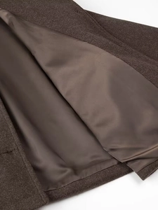 Brown wool coat with thick texture and smooth lining showing high-quality sewing craftsmanship