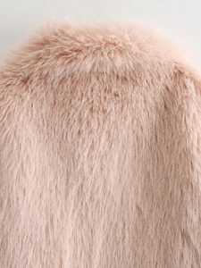 Close-up detail of soft pink faux fur coat showing plush texture and high-quality collar seam