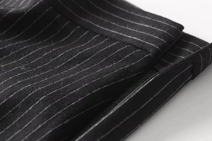 Macro shot of invisible side zipper and premium pinstripe wool blend fabric detail