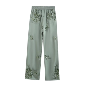 Detail view of bean green high-waisted wide-leg trousers with sequined floral embroidery