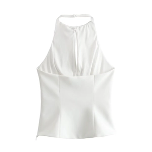Detail of white satin halter top featuring a refined front slit and elegant draped fabric