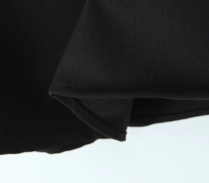 Macro shot of black fabric texture with detailed stitching for a mini A-line skirt