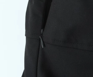Macro shot of invisible zipper detail and premium woven fabric on black mini skirt