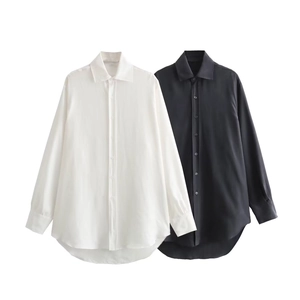 Detail showing asymmetric hem and satin texture of black and white long sleeve shirts