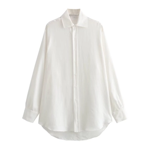 Detail of white satin long sleeve shirt with asymmetrical curved hem and glossy texture