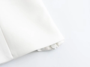 Detail of invisible zipper closure on white spring top with smooth fabric texture