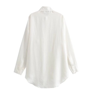 Rear view of white satin long sleeve blouse featuring a curved hem and minimalist design