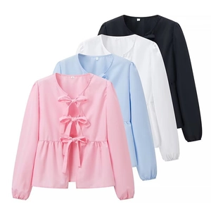 Detail view of long sleeve peplum shirts with front bow ties in four different colors