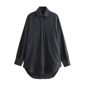 Detail of black silk texture shirt showing asymmetric curved hem and buttoned front