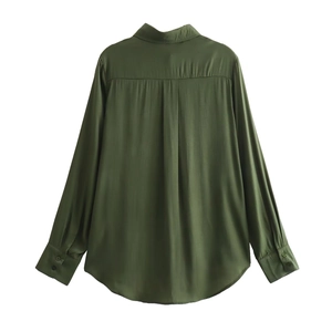 Detailed back view of dark green satin shirt showing center box pleat and curved hem