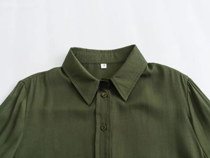 Detail of army green cotton shirt collar featuring classic lapels and size label