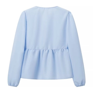 Detailed back view of a light blue long sleeve blouse with peplum hem and elastic cuffs