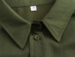 Close-up of olive green casual shirt featuring pointed collar and matching buttons detail