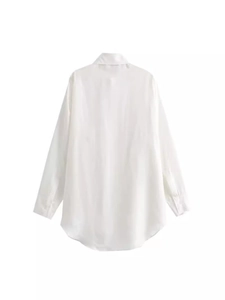 Back view of women's white satin long-sleeve shirt with lapel and asymmetrical hemline