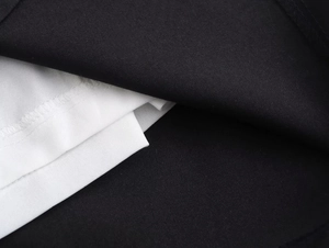 Vue détaillée du tissu noir avec doublure blanche et coutures blanches précises