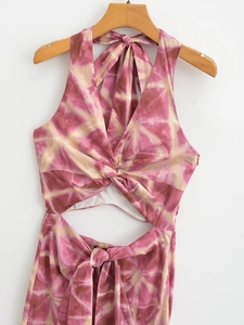 Pink tie-dye halter dress with front knot cutout and waist tie on a hanger
