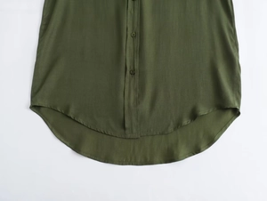 Detail view of deep olive green cotton linen shirt featuring high-low asymmetric hem