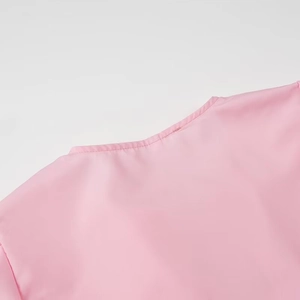 Close-up of pink casual shirt neckline featuring smooth stitching and high-quality fabric