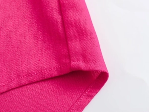 Detailed macro view showing the high-quality stitching and woven texture of magenta shirt