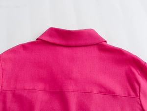 Detailed view of the rose red shirt neckline with high-quality stitching and fabric texture