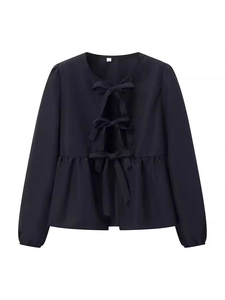 Women's black long sleeve top with bow ties and ruffled hem on white background