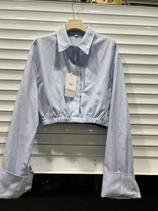 Short light blue cropped shirt with elastic hem and long sleeves in street fashion style