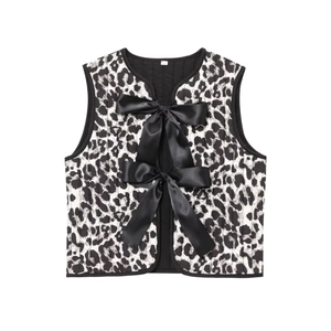 Close-up of leopard print quilted vest featuring large black satin decorative bows