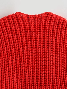 Detailed macro view of the thick chunky knit texture on this red Y2K style vest