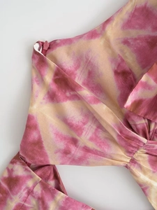 Detailed close-up of a pink tie-dye dress featuring side invisible zipper and pleat design