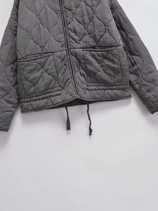 Dark grey quilted cotton jacket with a stand collar, large pockets and adjustable drawstring
