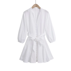 Detail of V-neck white broderie anglaise mini dress with buttons and belted waist