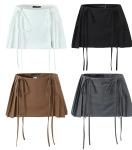Detail view of high-waist pleated mini skirt with ribbons and metal zipper in four colors