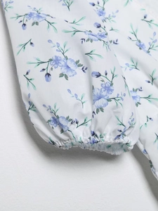 Floral V-neck dress with elastic ruffled cuffs and light blue blossom pattern print