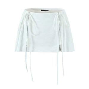 Detail view of white high-waist mini skirt with dual side zippers and long ribbons