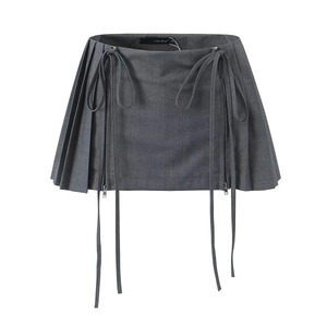 Detail view of dark grey pleated mini skirt with ribbon drawstring and side metal zippers