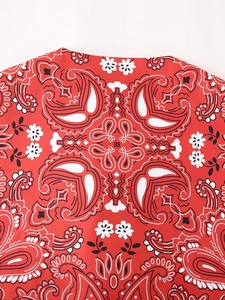Detail of red paisley print fabric with white and black floral patterns and soft texture