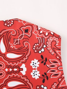 Detail view of red cotton vest featuring classic black and white paisley print fabric
