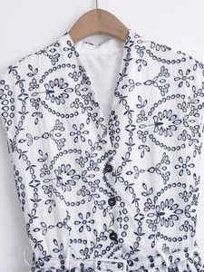 Sleeveless V-neck white dress with navy eyelet floral embroidery and waist tie belt